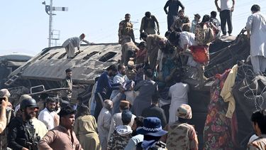 Security personnel and residents rescue injured blast victims from derailed carriages after an explosion targeted a train in Quetta on May 24, 2026. 

Banaras KHAN / AFP