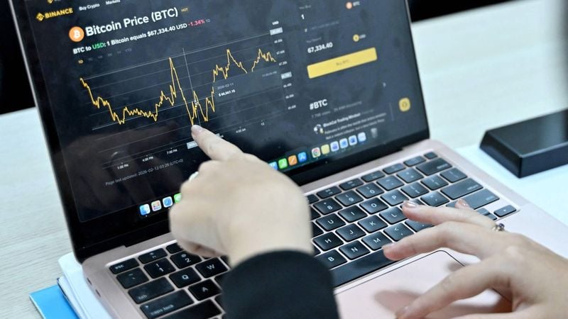 This photo taken on February 12, 2026 shows a Vietnamese cryptocurrency investor looking at the latest Bitcoin values on a laptop in Hanoi. As a first-year computer science student in Hanoi, Hoang Le started trading crypto from his university dorm room, egged on by his gamer friends who were making a killing, and at one point his digital holdings swelled to $200,000 -- around 50 times the average annual income in Vietnam. But they crashed to zero when the bottom fell out of bitcoin and other cryptocurrencies in recent months.

Nhac NGUYEN / AFP