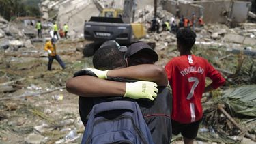 Two people hug as a backhoe loader removes rubble searching for survivors of the twin earthquakes, in Caraballeda, La Guaira State, some 40 km northeast of Caracas, on June 27, 2026. Three days after powerful tremors of magnitude 7.2 and 7.5 killed 1,430 people and left more than 50,000 missing, fury with perceived governmental inaction is mounting -- as is the feeling of helplessness.
Mauricio VALENZUELA / AFP