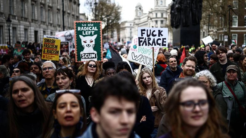 Protesters holding placards gather ahead of speeches after a march against the far right, organised by the Together Alliance, in central London on March 28, 2026. 
Henry NICHOLLS / AFP