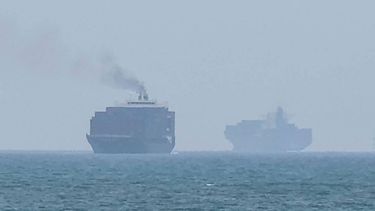 This frame grab taken from AFPTV video footage on July 12, 2026 shows cargo ships anchoring near the Strait of Hormuz off the eastern coast of the United Arab Emirates at Khor Fakkan. Tehran announced it was closing the Strait of Hormuz on July 12 and launched missiles and drones at its Gulf neighbours, in retaliation for new US strikes following an attack by Iranian forces on a merchant vessel that was abandoned in flames by its crew.
AFPTV / AFP