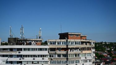Police and forensic investigators stand on the rooftop as they examine the location of impact (L) over a damaged apartment after a Russian drone struck an apartment building in Galati, eastern Romania. A Russian drone wounded two people as it struck an apartment building in NATO-member Romania, its defence ministry said on May 29, 2026, the latest spillover from the four-year war into neighbouring states. 
Daniel MIHAILESCU / AFP