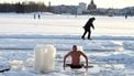 A winter swimmer takes a dip into water through sea ice in Helsinki, Finland on February 14, 2021. 
Jussi Nukari / Lehtikuva / AFP