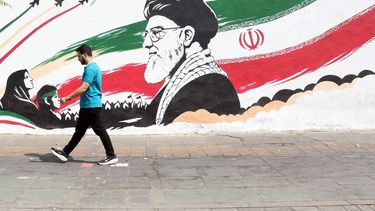 epa13165936 An Iranian man walks next to a wall painting featuring late Iranian supreme leader Ayatollah Ali Khamenei in a street in in central Tehran, Iran, 13 August 2026. Tensions between Iran and the US remain high as opposing claims persist over shipping control in the Strait of Hormuz.  EPA/ABEDIN TAHERKENAREH RESTRICTIONS: NO Access Israel Media/Persian Language TV Stations Outside Iran/Strictly No Access BBC Persian/VOA Persian/Manoto TV/Iran International TV. (As mandated by Iran's Directorate General for Foreign Media) --