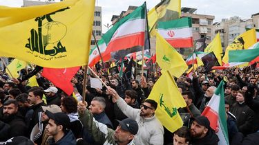 epa12787747 Hezbollah supporters carry Iranian and Hezbollah flags during a gathering in solidarity with the Islamic Republic of Iran in the Dahieh suburb of Beirut, Lebanon, 01 March 2026. Hundreds of Hezbollah supporters gathered to express their solidarity with the Islamic Republic of Iran and condemn the killing of the late Iranian Supreme Leader Ayatollah Ali Khamenei. According to a statement from Iranian state media issued on 01 March 2026, Khamenei was killed in an airstrike during a joint United States (US) and Israeli military campaign that began on 28 February 2026.  EPA/WAEL HAMZEH
