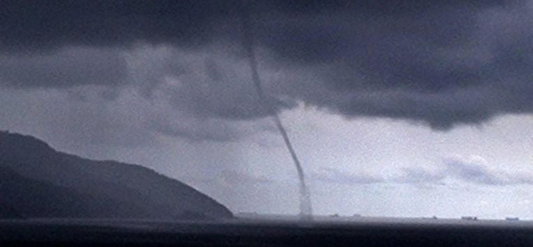 epa00162894 A tornado is seen from the Santos Fishing Club, in Ponta de la Playa, on the outskirts of Sao Paulo, Monday 29 March 2004. A cyclone that hit southern Brazil Sunday killed two people and left hundreds homeless as meteorologists debated whether it was the first hurricane ever recorded in the southern Atlantic Ocean. Winds exceeded 150 kilometres per hour and did damage in 20 cities, demolishing hundreds of trees. Officials worried that the death toll could rise because numerous people were missing on land and at sea. Two fishing boats with a total of 13 people on board, for instance, had not returned to port before the storm called Catarina hit. EPA/NATALIA BARLETTA RAMOS BRAZIL OUT