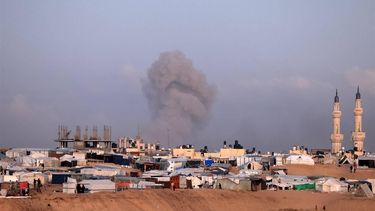 A picture taken from a makeshift camp for displaced Palestinians on the west of Rafah near the Egyptian border shows smoke billowing in Khan Yunis following Israeli bombardment on January 14, 2024, as the ongoing war between Israel and the militant Hamas group enters its 100th day. 
AFP
