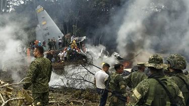 This screen grab shows soldiers and rescuers near an Air Force Hercules emitting thick smoke after the aircraft crashed during takeoff in Puerto Leguizamo, Colombia, near the southern border with Ecuador, on March 23, 2026. Colombia's military said on March 23 that about 80 troops were believed to be dead after a transport plane crash in the south of the country.
daniel ortiz / AFP
