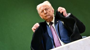 US President Donald Trump adjusts his jacket as he leaves the Congress Centre during the World Economic Forum (WEF) annual meeting in Davos on January 22, 2026. US President Donald Trump will show off his new 