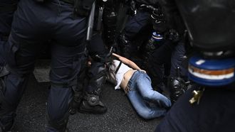 A protester lies on the ground as she is being detained by French law enforcement officers in riot gear during a demonstration in solidarity with high-school students near Sciences Politiques (Paris Institute of Political Studies) university as part of a nationwide protest movement over learning conditions in Paris, on October 7, 2026. Since late September, pupils have barred the entrances to hundreds of schools, complaining of teacher absences, overloaded timetables, dilapidated classrooms and buildings ill-adapted to rising temperatures, among other grievances.
JULIEN DE ROSA / AFP