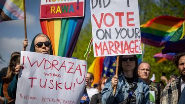 Participants wave rainbow flags and hold placards reading (from L) 'Tusk - Enforce The Ruling!', 'Equal Rights' and 'Did I vote on your marriage?' during a demonstration of LGBT organisations in Warsaw on April 25, 2026.  The LGBT organisations point out that the Polish government has not implemented landmark rulings of the European Court of Human Rights that require Poland to recognize same-sex marriages concluded in other EU member states.
Wojtek RADWANSKI / AFP