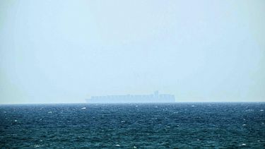 A large container ship sails past Khasab, on Oman’s northern Musandam Peninsula in the Strait of Hormuz, on June 24, 2025. Oil prices sank and stock markets jumped on June 24, even as uncertainty reined over a Israel-Iran ceasefire. World markets  fear that Iran could shut the Strait of Hormuz, a chokepoint for about one-fifth of the world's oil supply.
Giuseppe CACACE / AFP