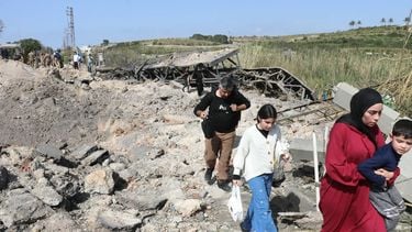 People cross on foot the Qasmieh bridge, the last bridge between the southern Lebanese cities of Tyre and Sidon regions, after it was targeted by an Israeli airstrike on April  16, 2026.  The Israeli military carried out two strikes against a key bridge in the south of Lebanon on April 16, destroying it, the state-run National News Agency (NNA) reported. 