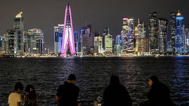 People sit facing the high-rise buildings at the Doha corniche promenade on July 21, 2026. 
Mahmud HAMS / AFP