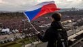 epa12839326 A protester holds a Czech flag as crowds gather at Letna Plain for the 'We Will Not Let Our Future Be Stolen' anti-government demonstration, in Prague, Czech Republic, 21 March 2026. According to the organizers Million Moments for Democracy, the mass protest drew hundreds of thousands to defend democratic values and civic engagement while pushing back against media pressure, defense cuts, and the erosion of state institutions.  EPA/MARTIN DIVISEK