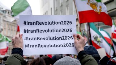 Protesters hold up a placard which reads #IranRevolution2026 during a demonstration against the Iranian government at Stephansplatz square in Vienna, Austria on January 11, 2026. 
Joe Klamar / AFP