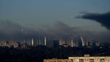 The Motherland Monument (L) and city skyline are seen through smoke rising above residential buildings following an air attack in Kyiv on September 23, 2026, amid the Russian invasion of Ukraine. 
Eugene KOTENKO / AFP