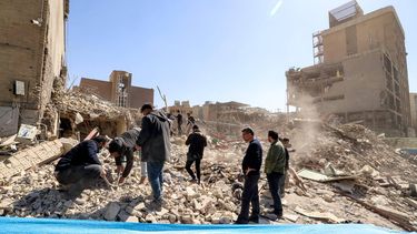 People inspect the rubble of a collapsed building near Ferdowsi square in Tehran on March 3, 2026. The United States and Israel started striking Iran on February 28, killing Iran's supreme leader and top military leaders, and prompting authorities to retaliate with strikes on Israel and across the Gulf.
ATTA KENARE / AFP