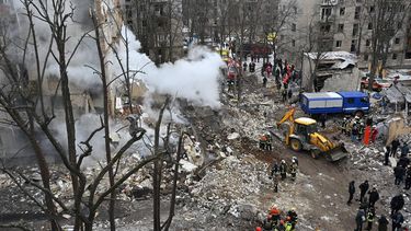 Ukrainian rescue workers clear debris at the site of a missile attack in Kharkiv on January 23, 2024, amid the Russian invasion of the Ukraine. Six people were killed and dozens wounded after a wave of Russian missiles targeted Kyiv and other cities across Ukraine, setting residential buildings ablaze and reducing others to rubble.
SERGEY BOBOK / AFP