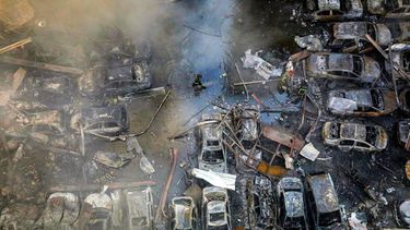 A firefighter walks past destroyed vehicles as colleagues attempt to extinguish a fire following an Israeli strike at the Corniche al-Mazraa neighbourhood of Beirut on April 8, 2026. Around 2:00 pm (1100 GMT), a series of Israeli strikes slammed into the Lebanese capital without warning, triggering scenes of panic. Israeli strikes on Lebanon on April 8, the heaviest since the war began in early March, left 