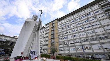 A picture shows the statue of John Paul II outside the Gemelli University Hospital, where Pope Leo XIV is recovering after undergoing surgery to remove a cancerous tumour from his right lung, in Rome on October 17, 2026. 

Tiziana FABI / AFP