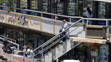 A woman checks her mobile phone while walking through a shopping arcade at the Sadeghiyeh Square in Tehran on May 31, 2026. Iran's chief negotiator warned the United States is not to be trusted, saying Tehran would not agree to any deal with Washington unless it fully secures Iranian rights.
ATTA KENARE / AFP