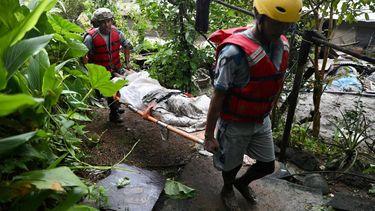 Rescue personnel carry the body of a victim who died after flash floods near Devighat, Bidur Municipality in Nepal's Nuwakot district on August 27, 2026. Nepal's disaster agency said that 823 people remained out of contact on August 27, more than 24 hours after a deadly flood tore through the border region with Tibet.
Prabin RANABHAT / AFP