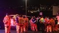 Emergency services workers gather at the scene after a shooting incident at Bondi Beach in Sydney on December 14, 2025. Two gunmen opened fire at Sydney's Bondi Beach on December 14, killing 11 people and wounding multiple others in a 