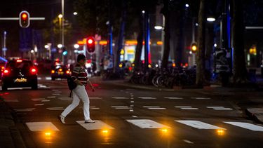Voetgangers steken de Coolsingel over via een interactief zebrapad, waarbij lampen in het wegdek oplichten als er iemand gaat oversteken. Foto: ANP | Robin van Lonkhuijsen 