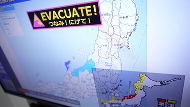 epa11052368 A tsunami warning is shown on a TV screen during a news broadcast in Tokyo, Japan, 01 January 2024. A strong earthquake hit a wide area on the Sea of Japan coast, recording a maximum intensity of 7 on the Japanese seismic scale in the Noto Peninsula and triggering a major tsunami warning in Ishikawa Prefecture. In addition to roads sinking and fires, houses have collapsed and water has been cut off.  EPA/FRANCK ROBICHON