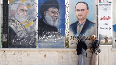 epaselect epa11055270 Armed Houthi supporters stand near paintings depicting (R-L) Houthi's political council head Mahdi al-Mashat, Hezbollah leader Hassan Nasrallah and Iranian slain General Qasem Soleimani, at a street in Sana'a, Yemen, 03 January 2024. Yemen's Houthis have launched two anti-ship missiles targeting a cargo ship in the Red Sea, according to a statement by the Houthis military spokesman Yahya Sarea, who added that the attack came after the ship's crew refused to respond to calls, including fiery warning messages. This is the 24th attack by the Houthis against merchant shipping in the Red Sea since 19 November 2023, the US Naval Central Command (CENTCOM) announced. The US Department of Defense announced on 18 December a multinational operation to safeguard trade and to protect ships in the Red Sea amid the recent escalation in Houthi attacks originating from Yemen. Houthis vowed to attack Israeli-bound ships and prevent them from navigating in the Red Sea and the Bab al-Mandab Strait in retaliation for Israel's airstrikes on the Gaza Strip, according to Sarea.  EPA/YAHYA ARHAB