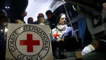 epa11004940 A member of the Red Cross looks on from inside a bus carrying released Palestinian prisoners from the Ofer Israeli military prison as it arrives in Ramallah, West Bank, 01 December 2023. A ceasefire deal between Israel and Hamas that started November 24 was extended for a second time on November 30 with 102 Hamas held hostages and 210 Palestinian prisoners released so far. More than 15,000 Palestinians and at least 1,200 Israelis have been killed, according to the Gaza Government media office and the Israel Defense Forces (IDF), since Hamas militants launched an attack against Israel from the Gaza Strip on 07 October, and the Israeli operations in Gaza and the West Bank which followed it.  EPA/ALAA BADARNEH