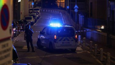 A police officer stands guard next to a police car after setting up a security perimeter on a street following an explosion that occurred in a residential building in Monaco, near the border with France on June 29, 2026. Three people were injured — two of them very seriously — in the explosion of an explosive device in Monaco in the evening. The blast at a residential building was 