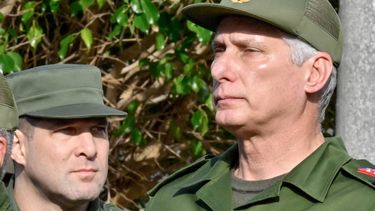 Cuba's President Miguel Diaz-Canel (R) and Cuba's Colonel Raul Guillermo Rodriguez Castro,  grandson of former President Raul Castro, attend the funeral of the 32 Cuban soldiers killed during the US incursion in Venezuela at Colon cemetery in Havana on January 16, 2026. 
ADALBERTO ROQUE / AFP